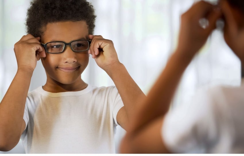 child trying on glasses
