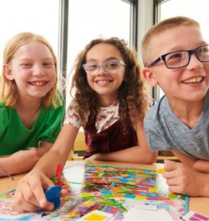 http://Elementary%20school%20students%20playing%20a%20board%20game%20in%20New%20Horizon%20Academy's%20before-and-after-school%20care%20program%20for%20school-age%20students