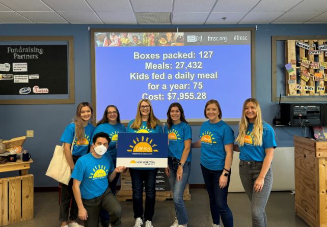 http://New%20Horizon%20Academy%20marketing%20team%20volunteering%20at%20Feed%20My%20Starving%20Children%20for%20Caring%20Beyond%20the%20Classroom