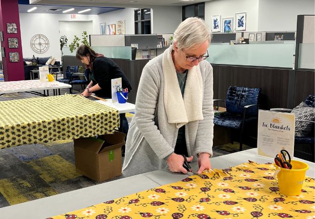 http://New%20Horizon%20Academy%20home%20office%20team%20making%20a%20tie%20blanket%20for%20Project%20Linus%20organization%20for%20Caring%20Beyond%20the%20Classroom