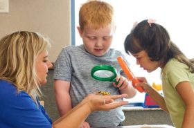 Preschool students doing a STEAM activity with their preschool teacher